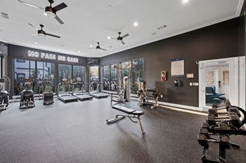 A gym with a variety of equipment including treadmills, weights, and exercise machines. at The Ambrose, Texas